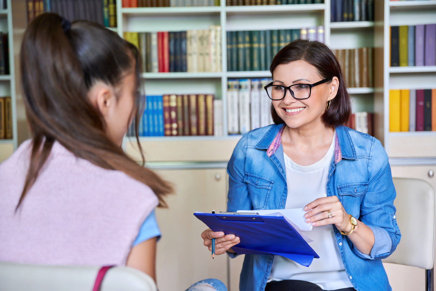 Woman School Psychologist, Teacher, Social Worker, Mentor Working with Teenage Girl